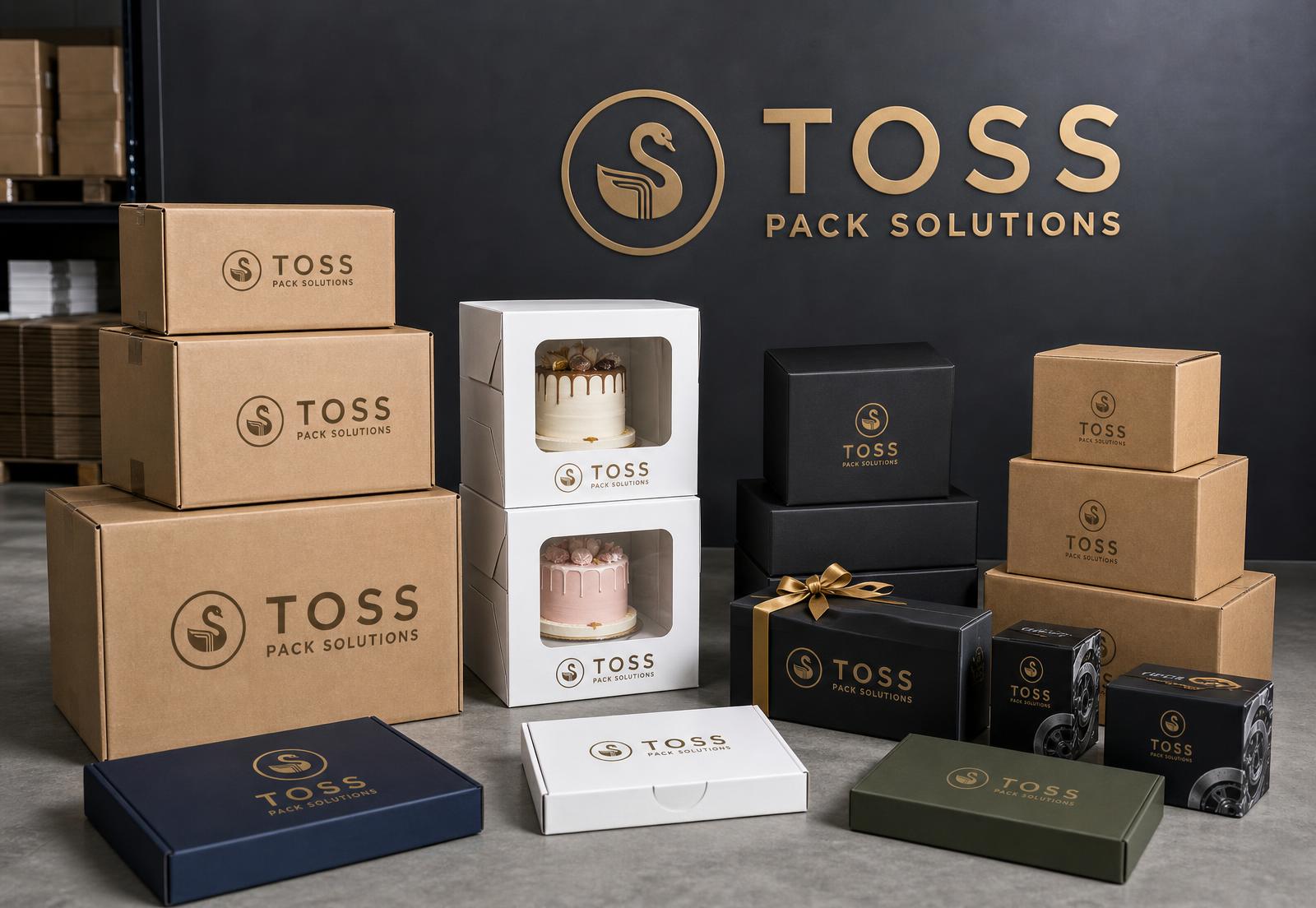 Stacked TOSS Pack Solutions branded custom, cake, gift and corrugated packaging boxes in a studio warehouse